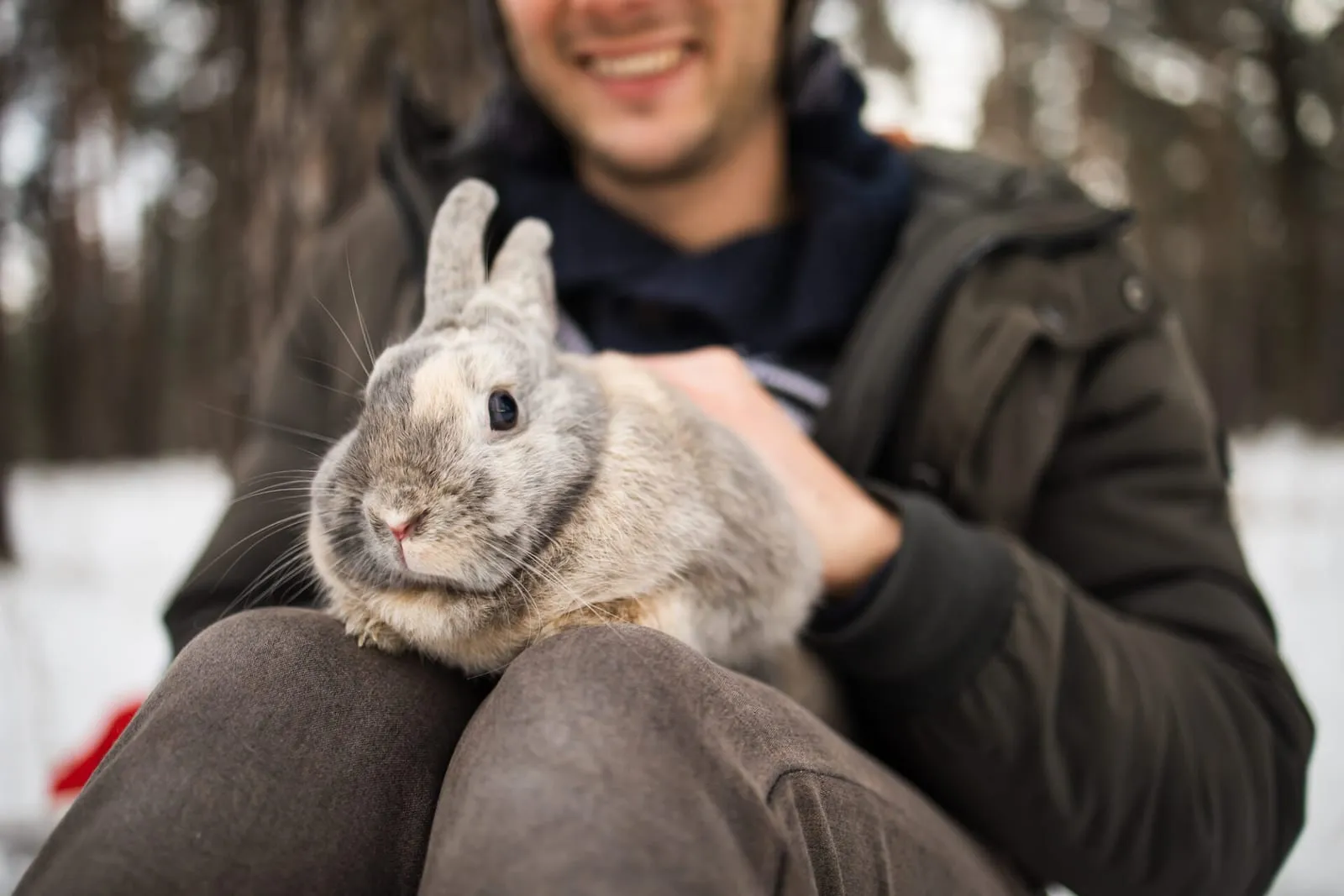 Man holding a rabbit in the snow