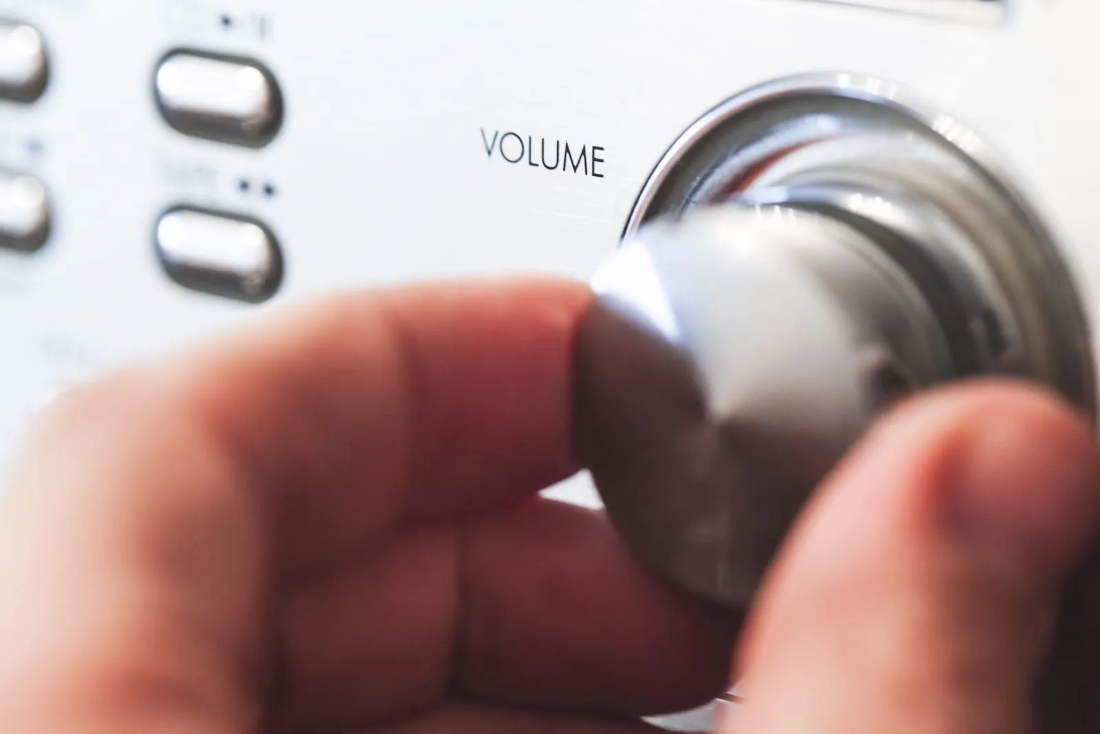 Hand on a volume control knob