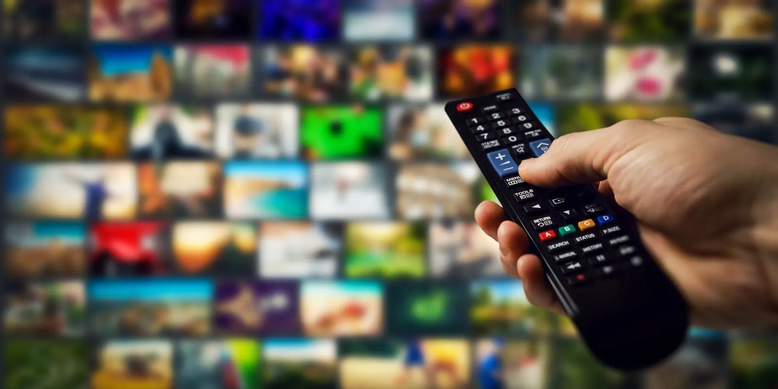 Remote control pointing at a blurred TV screen