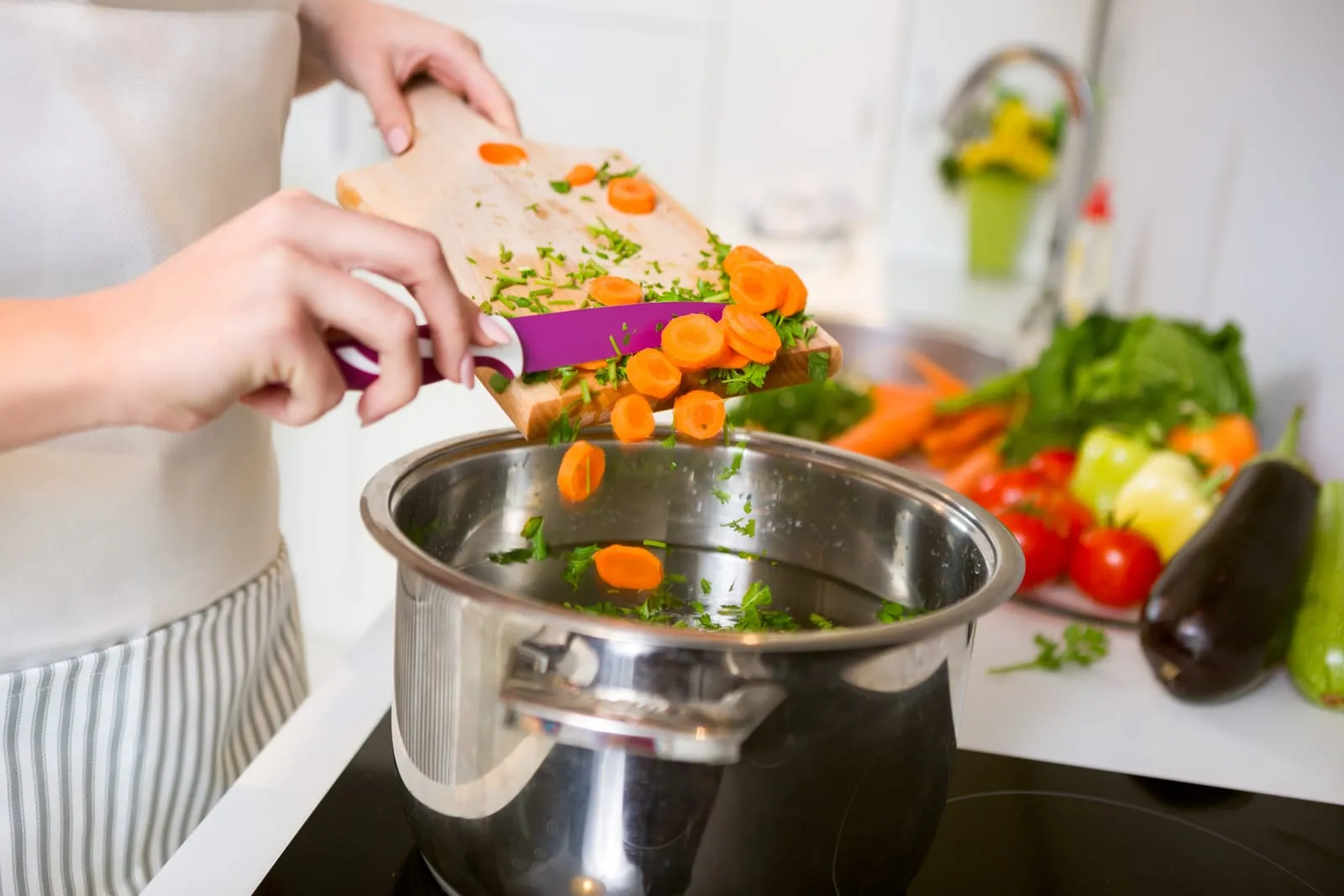 Chopped vegetables being put into a pot